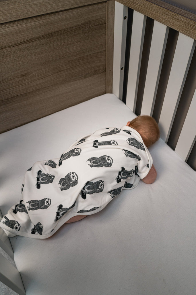 The skating sloth baby blanket from Doctor Mother Other makes a perfect newborn gift. Made from 100% cotton and handmade in the UK.